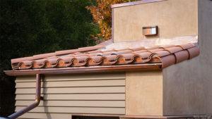 Photograph of a roof with spaces between roof decking and covering blocked to prevent ember intrusion.